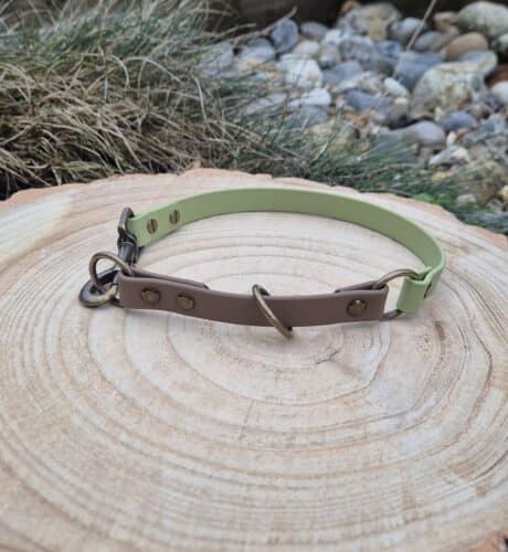Quick-snap customisable dog collar in brown and sage green Biothane, displayed on natural wood with brass fittings and metal D-ring.