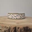 Printed Hound Collar in soft pink, black and sage tones, displayed on natural wood with taupe hardware and quick-snap closure.