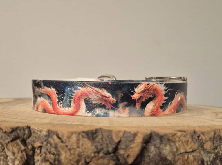 Handmade BioThane dog collar featuring vibrant red dragons on dark background, displayed on wooden surface.