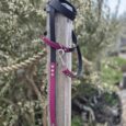Custom 2m multi-way double-ended lead in burgundy and black BioThane, wrapped around wooden post with traffic handle detail visible.