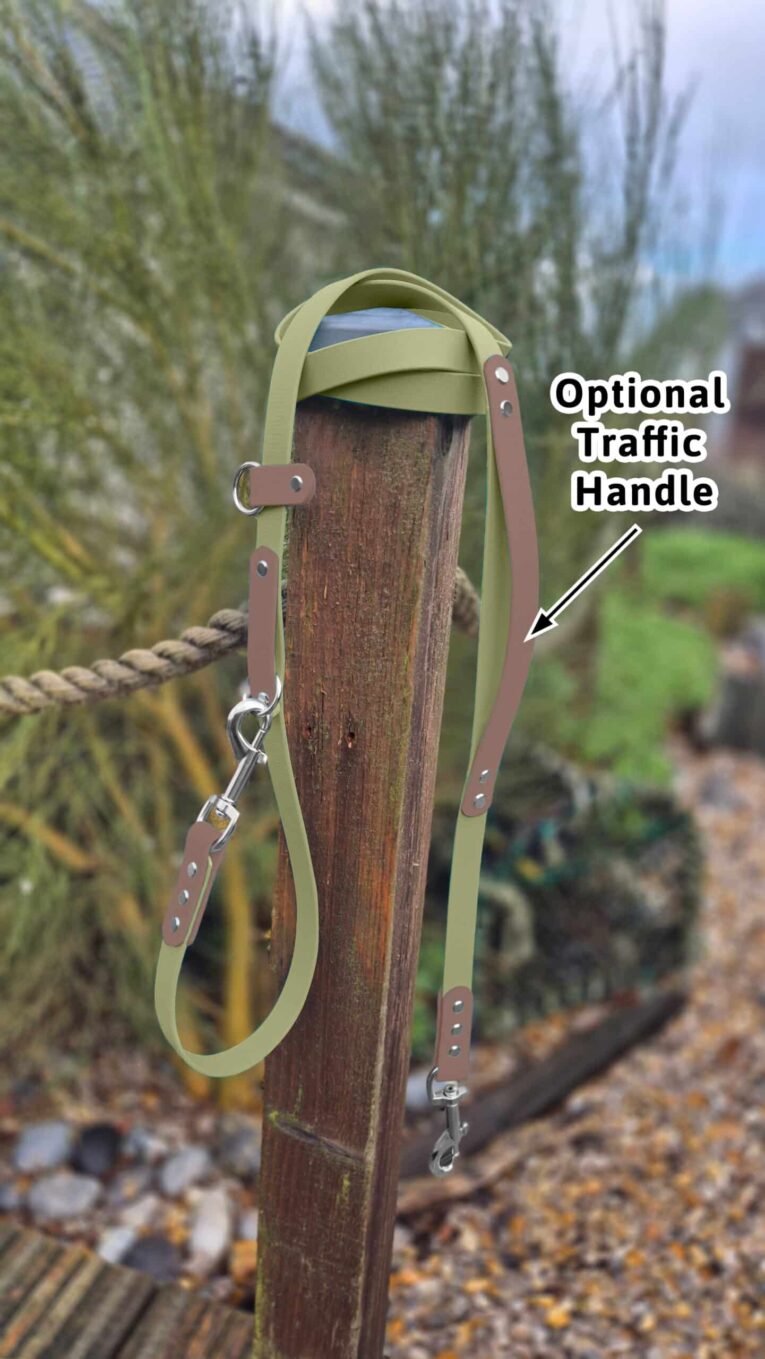 Avocado-coloured BioThane dog collar with optional traffic handle, displayed on wooden post outdoors.