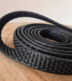 Close-up super grip BioThane longline showing dimpled surface texture and layered construction.