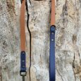 Handmade BioThane dog lead and collar in harbour wood colour with brass hardware, displayed on weathered wood.