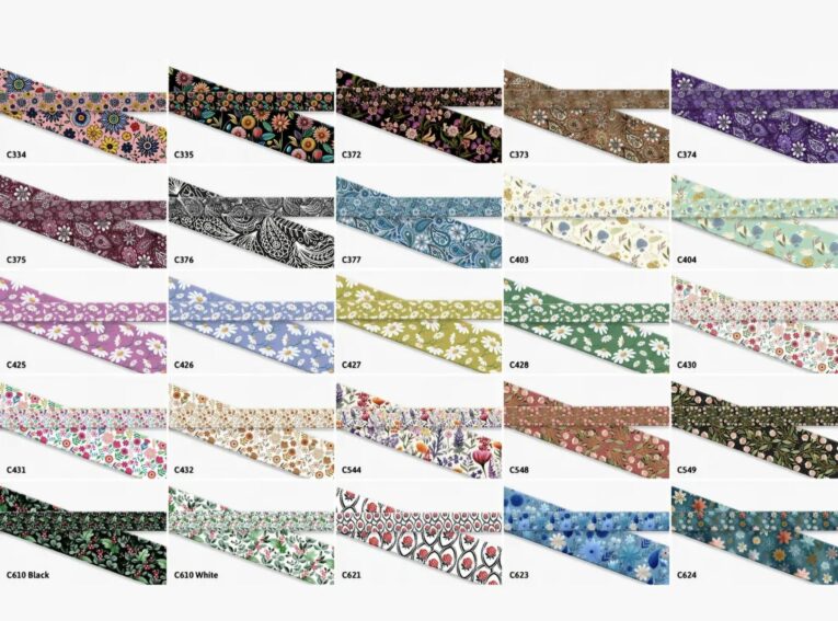 Colourful printed BioThane dog collar designs displayed in a grid layout, showing floral patterns and vibrant colour options.