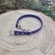 Deep purple BioThane slip collar with chrome hardware, displayed on natural wood