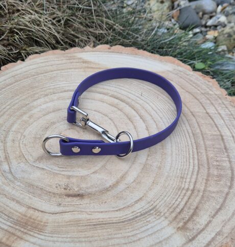 Deep purple BioThane slip collar with chrome hardware, displayed on natural wood
