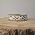 Handmade BioThane hound collar with dual-layer design, featuring pink, black and cream abstract patterned webbing on natural-coloured base.