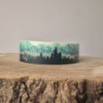 Forest print handmade BioThane dog collar featuring layered mountain and evergreen tree design in green and black tones.