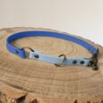 Blue and light blue handmade BioThane dog collar half slip with clip on natural wood surface.