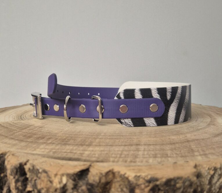 Purple BioThane patterned tapered collar with zebra-striped detail and metal D-rings on wooden surface.