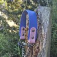 Periwinkle and mauve handmade BioThane dog collar with chain lead, displayed on weathered wood post.