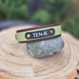 Personalised TEN-K BioThane collar in sage green and burgundy with navy nameplate and brass fixings.