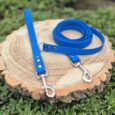 Bright blue handmade BioThane longline with traffic handle and waterproof longline lead on wooden background.