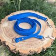 Blue waterproof longline with detachable handle and dual metal clasps on wooden display.