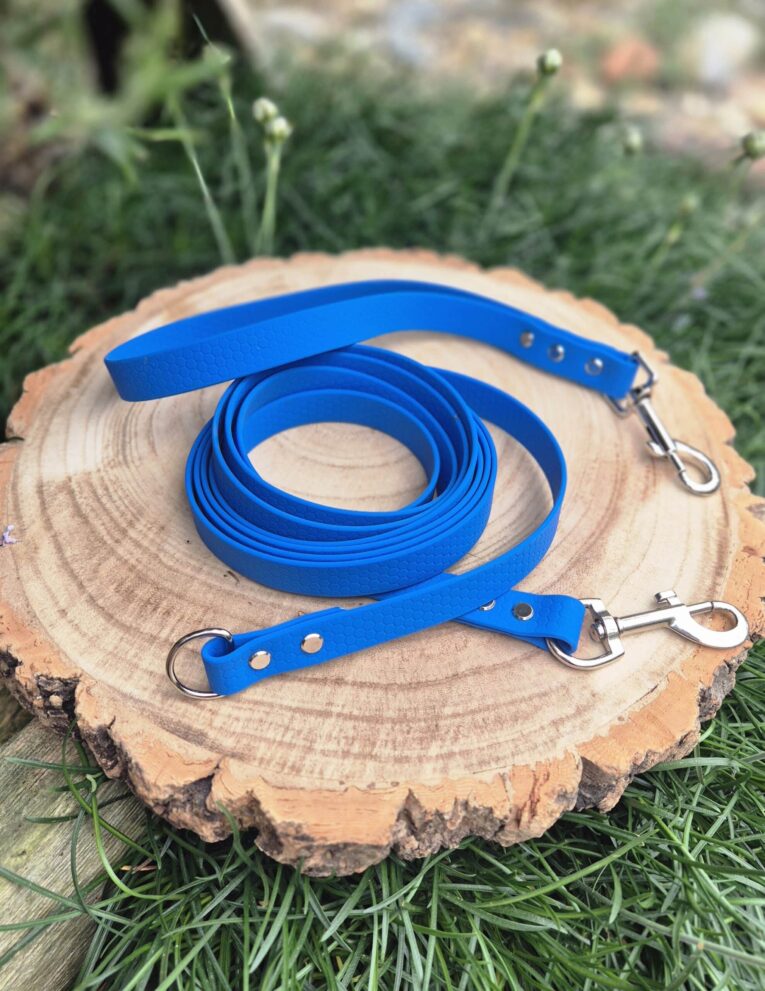 Blue waterproof longline with detachable handle and dual metal clasps on wooden display.