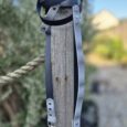 Waterproof printed BioThane lead with navy webbing and silver hardware, coiled around wooden post.