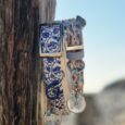 Coastal printed BioThane collar with matching personalised resin tag featuring initial D, displayed on weathered wood.