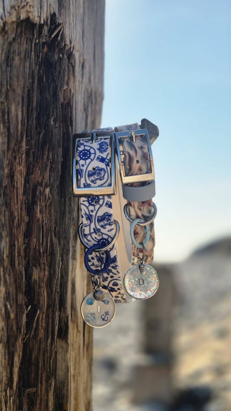 Coastal printed BioThane collar with matching personalised resin tag featuring initial D, displayed on weathered wood.