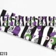 Halloween-themed handmade dog collar with black and white stripes, purple accents, skulls, eyeballs, gravestones and spooky graphics.