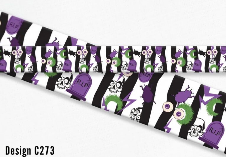 Halloween-themed handmade dog collar with black and white stripes, purple accents, skulls, eyeballs, gravestones and spooky graphics.