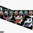 Vibrant halloween-themed dog collar design featuring colourful monster skulls with bright tongues on black BioThane.