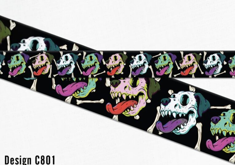 Vibrant halloween-themed dog collar design featuring colourful monster skulls with bright tongues on black BioThane.