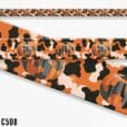 Handmade BioThane dog collar in orange with black and white cow print and pumpkin design details.