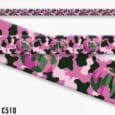 Pink pumpkin print handmade BioThane dog collar with black and green accents, displayed rolled.