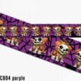 Purple Halloween pumpkin skeleton dog collar with spider web pattern design and spooky printed characters